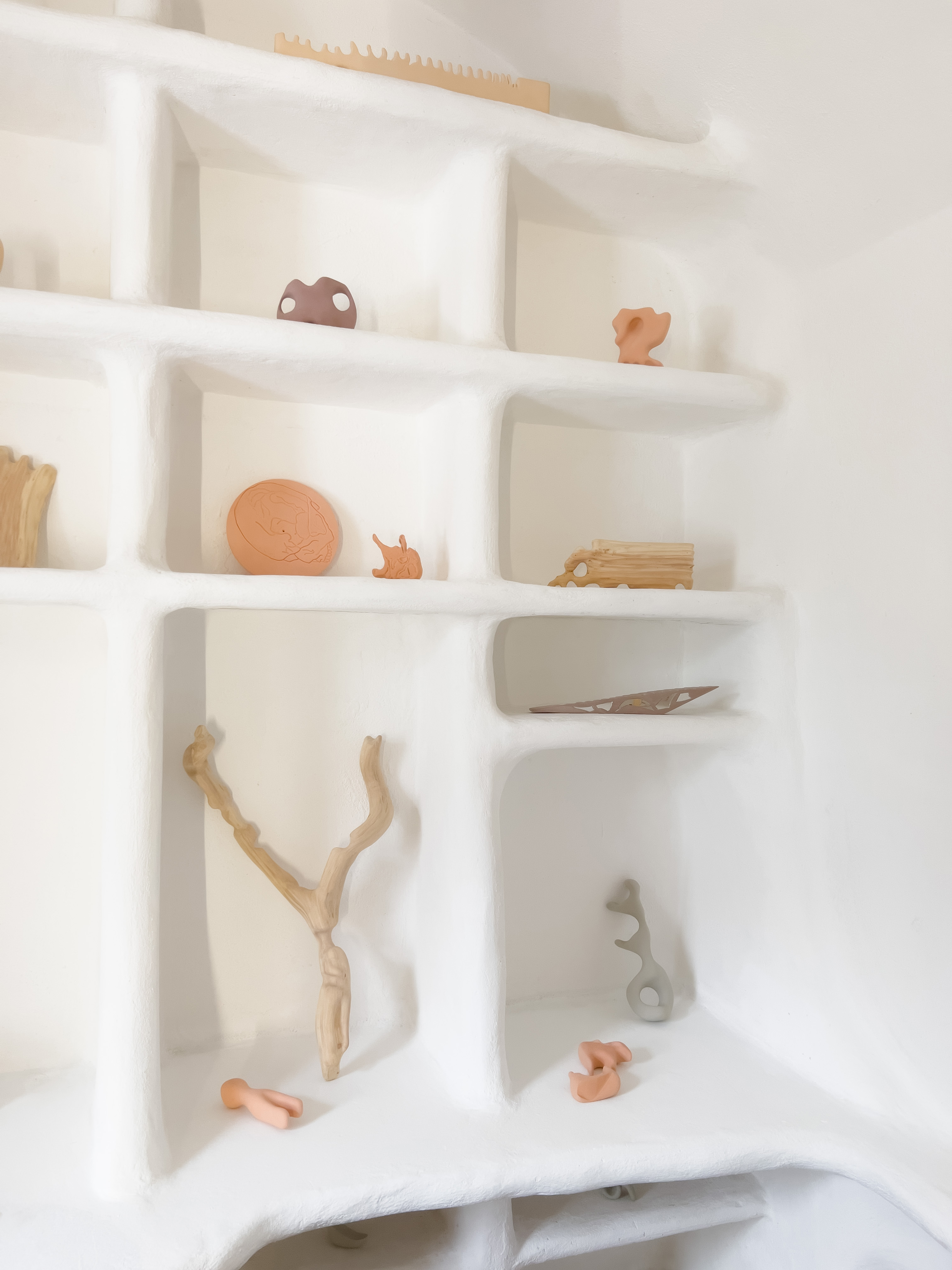 Photo of an art installation called Hands (and Other Products of Labor) 2.0 by Klára Čermáková (Common Space, Altes Spital, Viechtach, Germany) [Detail]. A detailed look at the art objects in the back of the space/shelves.
