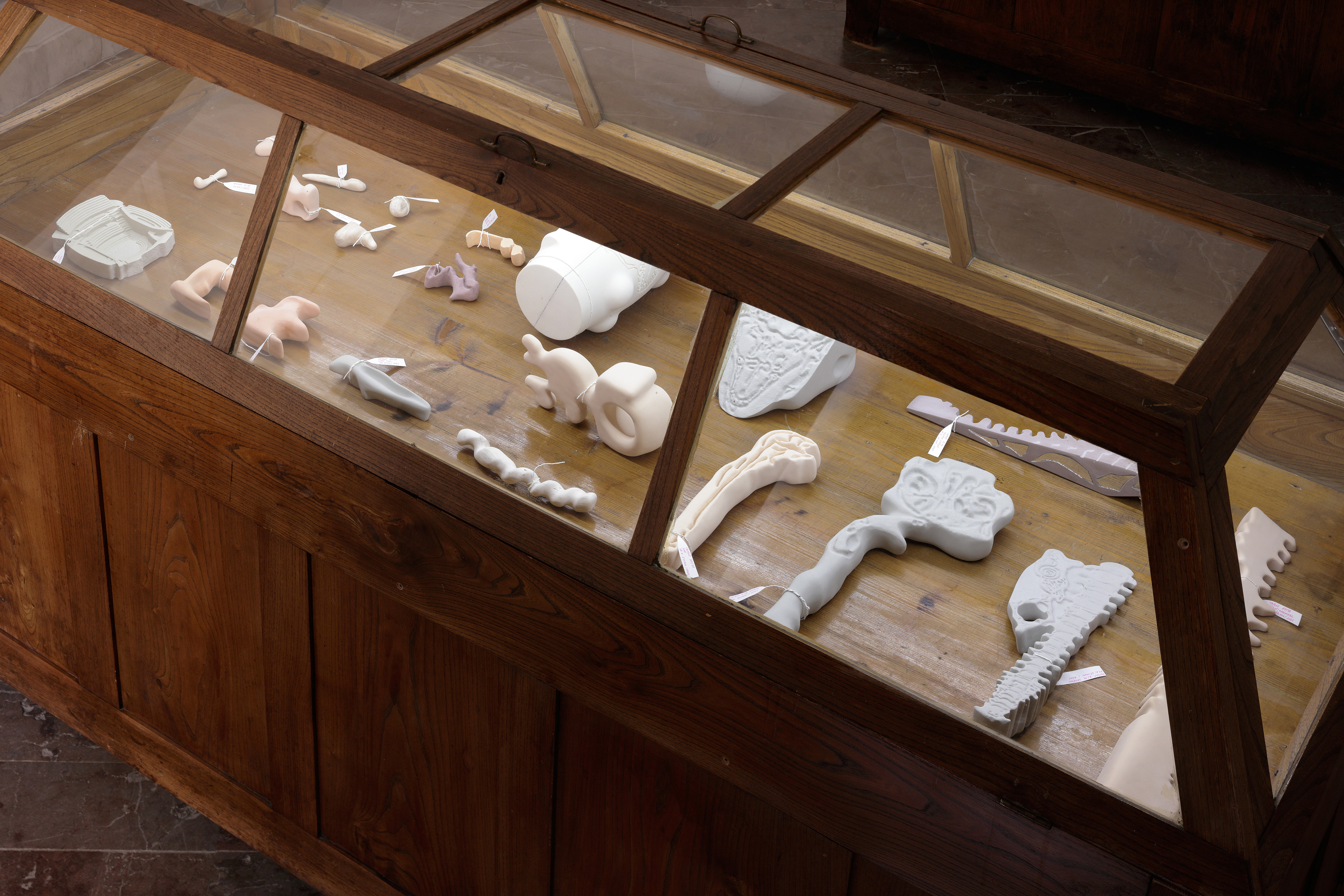 Photo of an art installation called Hands (and Other Products of Labor) 2.0 by Klára Čermáková (Mikulov Art Symposium, Mikulov, Czechia, 2021) [Detail no. 1]. A detailed look at the art objects in one of the “coffins.”