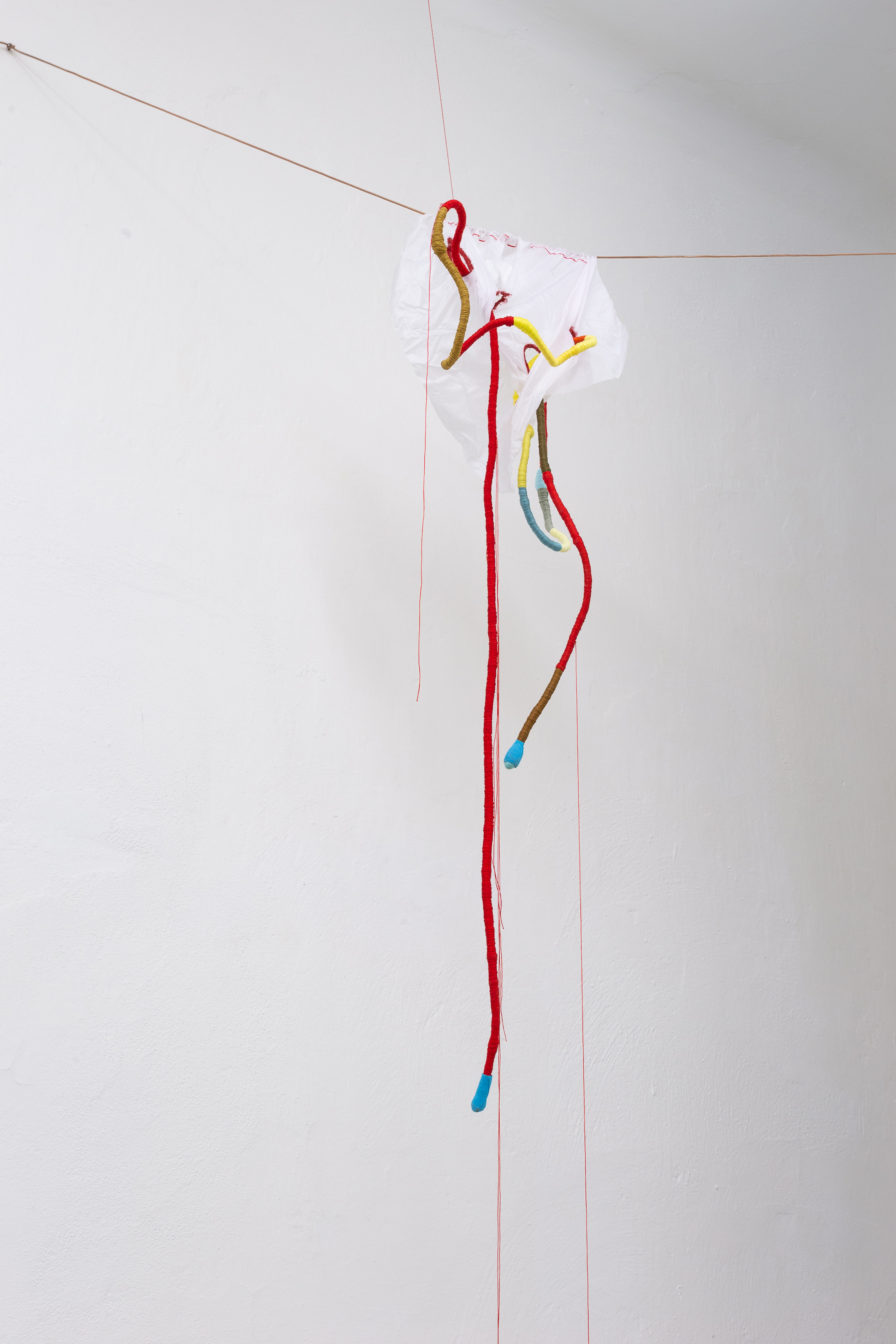 Photo of an art installation called Hands (and Other Products of Labor) 2.0 by Klára Čermáková (Mikulov Art Symposium, Mikulov, Czechia, 2021) [Detail no. 4]. A detailed view of a smaller sewn object located in one of the upper corners of the main room.